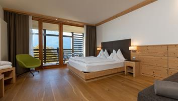 A double room with wooden floor and balcony