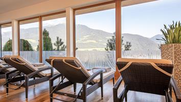 Loungers at the indoor pool with a mountain view