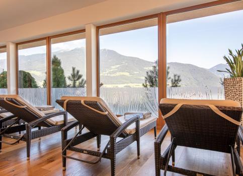 Loungers at the indoor pool with a mountain view