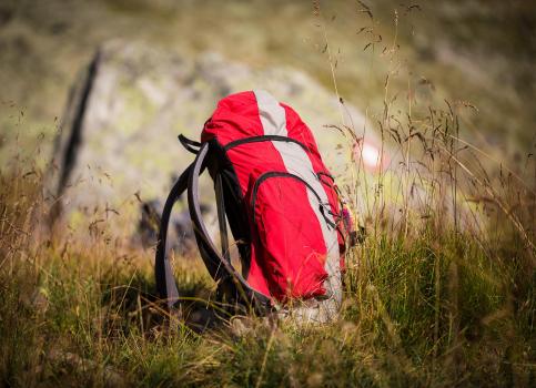 A hiking backpack on grass