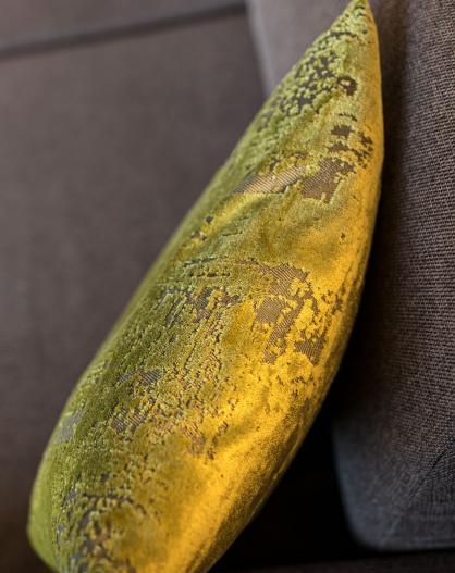 A green pillow on a couch