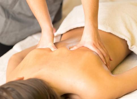 A woman is receiving a back massage