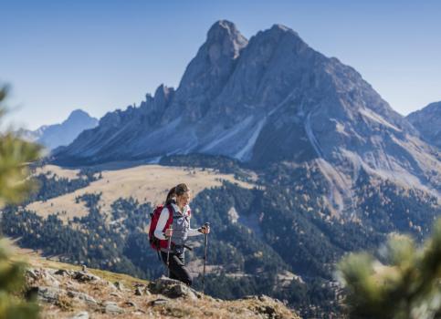 A woman is hiking in the mountains