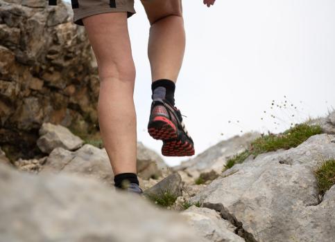 Close-up of a hiker’s legs on a rocky trail